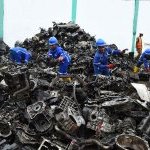 Workers gather piles of scrap automobile aluminium and metals for recycling at Romco factory in Lagos, on August 26, 2022 (Photo: ©Pius Utomi Ekpei / AFP)